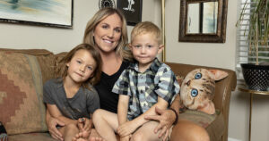 noell whaley and her kids sitting on living room couch with artwork in background