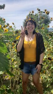sarah verdugo surounded by sunflowers