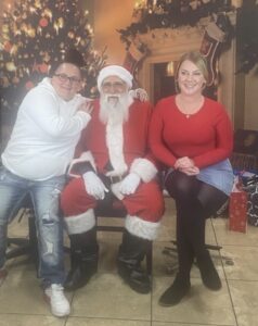 two empowerment center reno addiction treatment center employees with santa at holiday party
